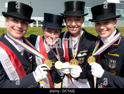 Herning, Denmark. 22nd Aug, 2013. German dressage riders (L-R) Isabell Werth, Helen Langehanenberg, Fabienne Luetkemeier and Kristina Sprehe present their gold medals after winning the team competition of the FEI European Championships in Herning, Denmark, Germany, 22 August 2013. Photo: Jochen Luebke/dpa/Alamy Live News Stock Photo