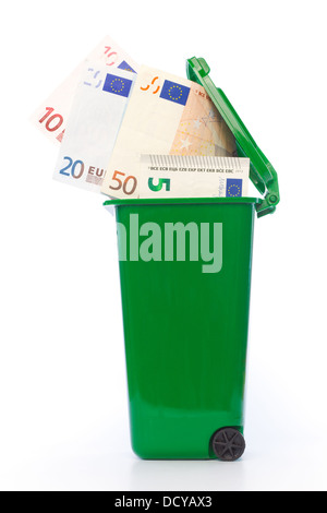 Euro banknotes in green wheelie bin against white background Stock Photo