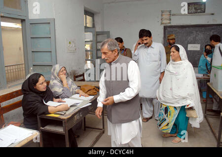 Awami National Party (ANP) Leader, Ghulam Ahmad Bilour visits Shahab-ud-Din School during by-election in Peshawar on Thursday, August 22, 2013. Superintendent of the Police (SP) City Mohammad Ismail told reporters Wednesday that 2,600 personnel, including 450 policewomen and 350 LHWs and policemen, will be deployed in Peshawar to maintain order during the by-elections. Army will be assisting the police in security duty in the wake of serious threats of attacks. Stock Photo