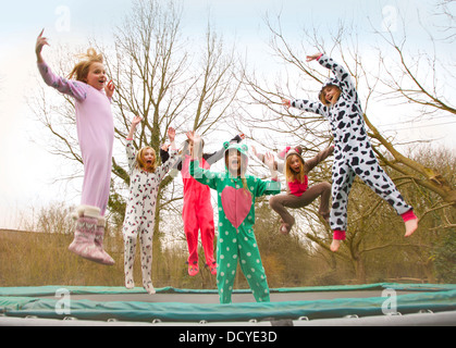 Group of Girls Wearing Animal Costumes Bouncing on Trampoline