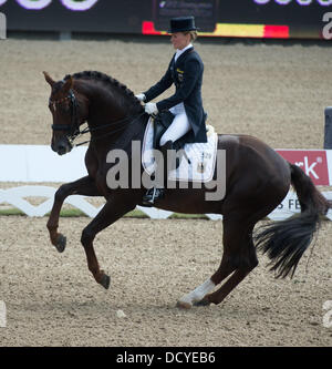 Herning, Denmark, Germany. 22nd Aug, 2013. German dressage rider Helen Langehanenberg cheers performs her skills with her horse Damon Hill at the team competition of the FEI European Championships in Herning, Denmark, Germany, 22 August 2013. Photo: Jochen Luebke/dpa/Alamy Live News Stock Photo