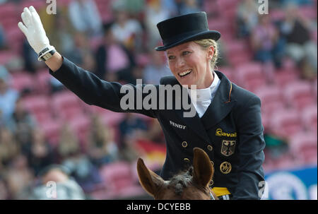 Herning, Denmark, Germany. 22nd Aug, 2013. German dressage rider Helen Langehanenberg cheers after her run on her horse Damon Hill during the team competition of the FEI European Championships in Herning, Denmark, Germany, 22 August 2013. Photo: Jochen Luebke/dpa/Alamy Live News Stock Photo