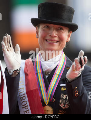 Herning, Denmark, Germany. 22nd Aug, 2013. German dressage rider Isabell Werth applauds during the victory ceremony of the team competition of the FEI European Championships in Herning, Denmark, Germany, 22 August 2013. The German team finished first. Photo: Jochen Luebke/dpa/Alamy Live News Stock Photo