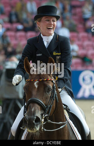 Herning, Denmark, Germany. 22nd Aug, 2013. German dressage rider Helen Langehanenberg cheers after her run on her horse Damon Hill during the team competition of the FEI European Championships in Herning, Denmark, Germany, 22 August 2013. Photo: Jochen Luebke/dpa/Alamy Live News Stock Photo