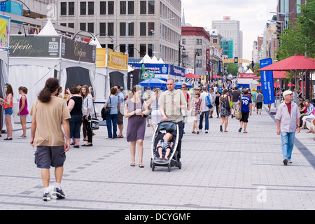 Pedestrians on a part Ste Catherine street which is closed to ...