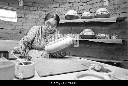 An elderly Indian woman from Jemez Indian Pueblo in New Mexico hand makes traditional Indian pottery, circa 1978 Stock Photo