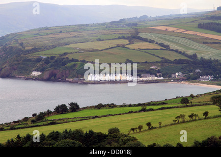 The small seaside village of Cushendun nestles amid the green rolling of  County Antrim, Northern Ireland Stock Photo