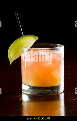 classic cocktail, madras, vodka cranberry and orange juice served in a glass on a dark bar Stock Photo