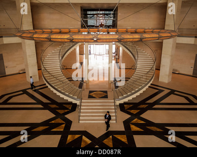 Mosaic star tiled foyer aerial view of circular marble staircase  and tourists in the Museum of Islamic Art in Doha, Qatar Stock Photo
