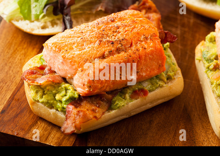 Grilled Salmon Sandwich with Bacon and Guacamole on Bread Stock Photo