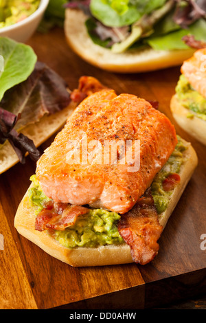 Grilled Salmon Sandwich with Bacon and Guacamole on Bread Stock Photo