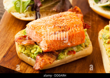 Grilled Salmon Sandwich with Bacon and Guacamole on Bread Stock Photo