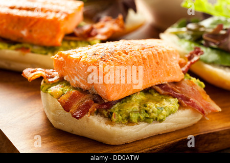 Grilled Salmon Sandwich with Bacon and Guacamole on Bread Stock Photo