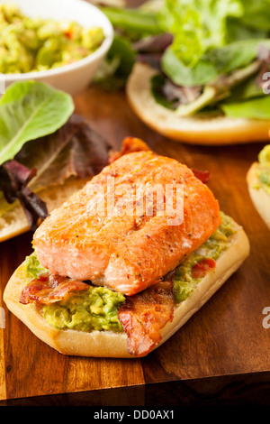 Grilled Salmon Sandwich with Bacon and Guacamole on Bread Stock Photo