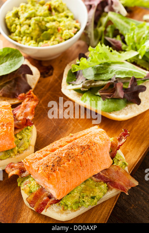 Grilled Salmon Sandwich with Bacon and Guacamole on Bread Stock Photo