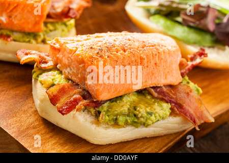 Grilled Salmon Sandwich with Bacon and Guacamole on Bread Stock Photo