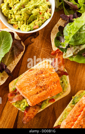 Grilled Salmon Sandwich with Bacon and Guacamole on Bread Stock Photo