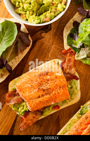 Grilled Salmon Sandwich with Bacon and Guacamole on Bread Stock Photo