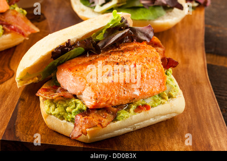 Grilled Salmon Sandwich with Bacon and Guacamole on Bread Stock Photo