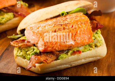 Grilled Salmon Sandwich with Bacon and Guacamole on Bread Stock Photo