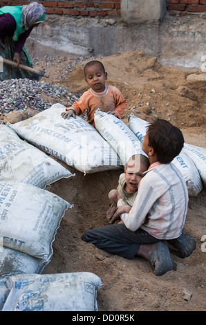 Children on the street playing in a building site - Jodhpur, Rajashtan, India Stock Photo