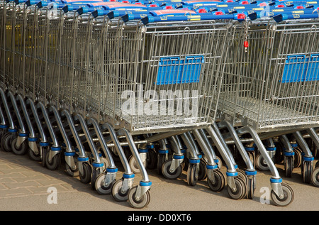 A row of parked shopping carts equipped with coin-operated locking mechanisms Stock Photo