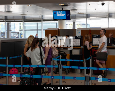 The bag drop in the check-in area at Copenhagen Airport, CPH, in Kastrup, Denmark. Stock Photo