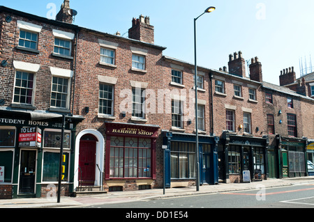 Terraced houses with a row of shops, Mount Pleasant, Liverpool, UK Stock Photo
