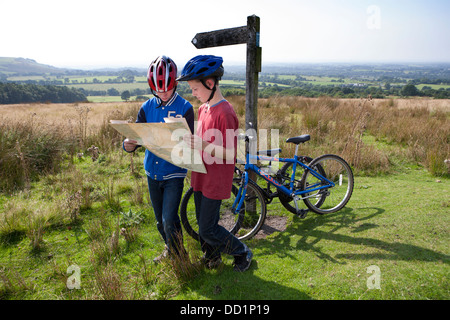 a map reading summer tourist boy outdoors trip hiking child kid male kids, vacation holiday boys children walking trek cyclist cycling kids boys UK Stock Photo