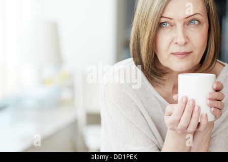 Portrait of calm mature woman with cup Stock Photo