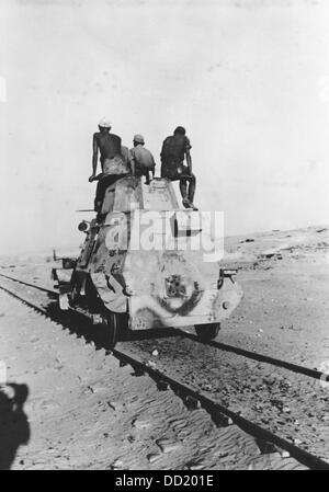 The image from the Nazi Propaganda! shows soldiers of the German Wehrmacht with a locomotive which was reconstructed as an armored reconnaissance car near Tobruk, Libya, published 31 August 1942. Fotoarchiv für Zeitgeschichte Stock Photo