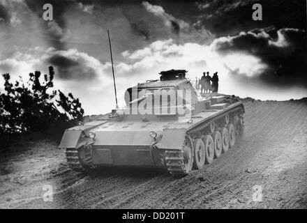 Tank of the German Wehrmacht during a maneuver at the military training ground in Wünsdorf in November 1938. The Nazi Propaganda! on the back of the picture is dated 26 November 1938: 'Tank attack! A grand maneuver of the armored command Wünsdorf. A large scale maneuver of the German armored command took place on the military training ground in Wünsdorf. Without interruption, the fast tanks rolled across the partially fogged premises to attack quickly. But also the antitank defense was on alert and shot at the 'enemy' from well camouflaged positions.' Fotoarchiv für Zeitgeschichte Stock Photo