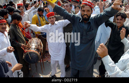 Supporters of Awami National Party dance on traditional tunes on the victory of ANP Leader, Haji Ghulam Ahmad Bilour in By-Election 2013 for NA-1 during celebration demonstration in Peshawar on Friday, August 23, 2013. Stock Photo