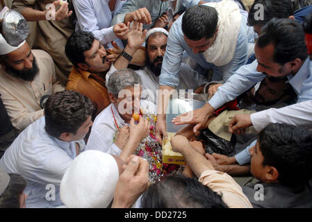 Awami National Party (ANP) Leader, Haji Ghulam Ahmad Bilour meets to his supporters after his victory in By-Election 2013 for NA-1 during celebration in Peshawar on Friday, August 23, 2013. Stock Photo