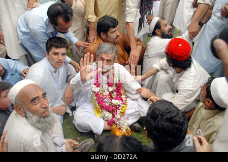 Awami National Party (ANP) Leader, Haji Ghulam Ahmad Bilour meets to his supporters after his victory in By-Election 2013 for NA-1 during celebration in Peshawar on Friday, August 23, 2013. Stock Photo