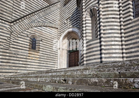 Orvieto Duomo - detail of side wall with black and white striped stone, curved walls and decorations causing dramatic patterned