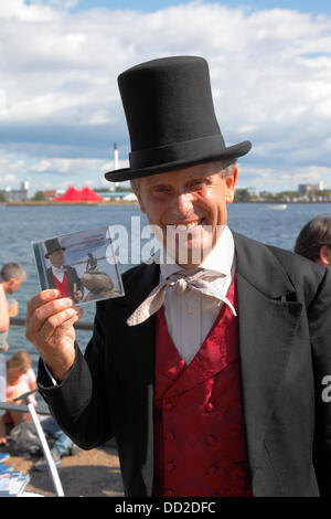 Copenhagen, Denmark, August 23, 2013. The Little Mermaid turns 100 today and Copenhagen throws her a party to celebrate her centenary with thousands of visitors in a day-long programme honouring the Hans Christian Andersen figure and icon.  H.C.Andersen walks around and says hello to the children.  Here is actor and H.C. Andersen interpreter and impersonator Christian Steffensen with his CD “The Little Mermaid”. Credit:  Niels Quist/Alamy Live News Stock Photo