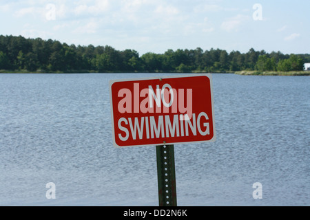 Red sign warning against swimming Stock Photo