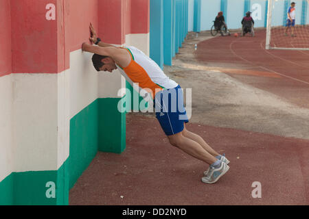 Duhok, Iraqi Kurdistan. 22nd August 2013.   Iraqi paralympic team during training. They choose the kurdistan province for their training due to the stability and peceful environment. In this picture NAAS Ahmed. AL-DABBAGH Fadhil, silver medal in long jump and triple jump, 2011. He was injured when 6 years old, by a mine. Credit:  Francesco Gustincich/Alamy Live News Stock Photo