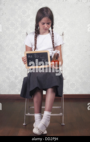 a schoolgirl with an apple and a blackboard Stock Photo