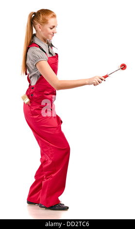 Young woman in red overalls with painting tools , isolated on white Stock Photo