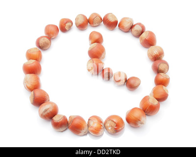 Hours of hazelnut on white background Stock Photo