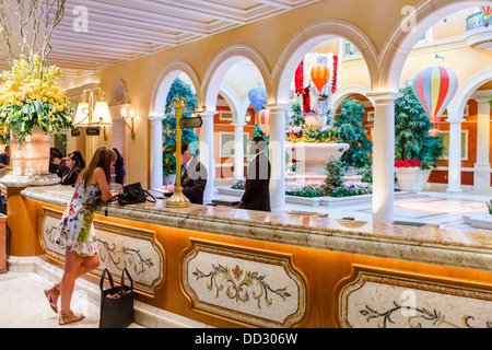 Woman checks in at the lobby of the Bellagio Hotel Las Vegas Stock Photo