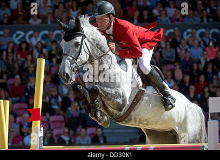 Herning, Denmark. 24th Aug, 2013. German equestrian Ludger Beerbaum performs a jump on his horse Chiara in the first round of the single final event at the FEI European Championships in jumping and dressage in Herning, Denmark, 24 August 2013. Photo: Jochen Luebke/dpa/Alamy Live News Stock Photo
