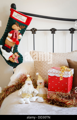 Cozy home at Christmas time with present on the bed Stock Photo