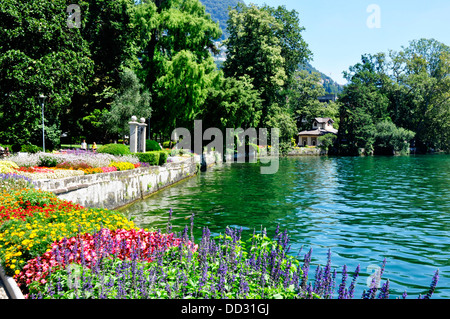 Switzerland - Lake Lugano - Lugano town - gardens beside the lake - display of summer flowers - sunlight - blue sky Stock Photo