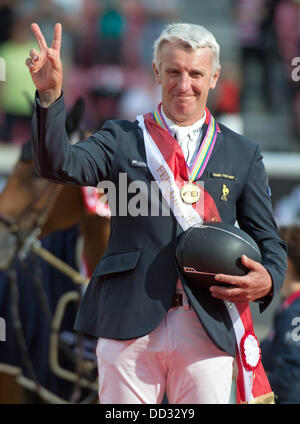 Herning, Denmark. 24th Aug, 2013. French show jumper Roger Yves Bost gesticulates after his victory in the first round of the single final event at the FEI European Championships in jumping and dressage in Herning, Denmark, 24 August 2013. Photo: Jochen Luebke/dpa/Alamy Live News Stock Photo