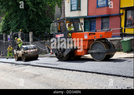 Large and small road rollers compacting asphalt during road resurfacing Stock Photo