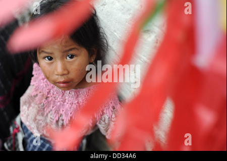 Guatemala indigenous girl in guipil and corte at kite festival on day of the dead in Sumpango, Sacatepeque, Guateamala. Stock Photo