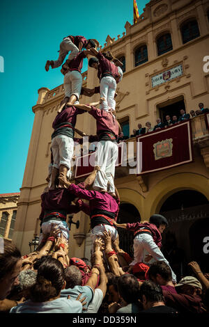 Sitges, Spain. August 24th, 2013: The castellers of the 'Jove de Sitges' build a human tower known as 'castell' in front of the town hall of Sitges during the Festa Major Credit:  matthi/Alamy Live News Stock Photo